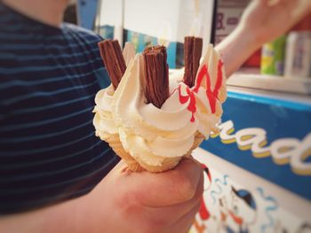 Close-up of hand holding ice cream