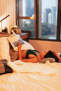 Woman sleeping on bed at home