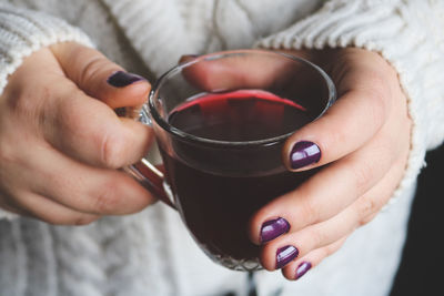 Midsection of woman holding tea