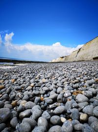 Surface level of rocks against blue sky