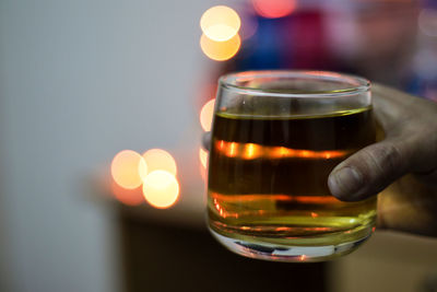 Close-up of hand holding beer glass