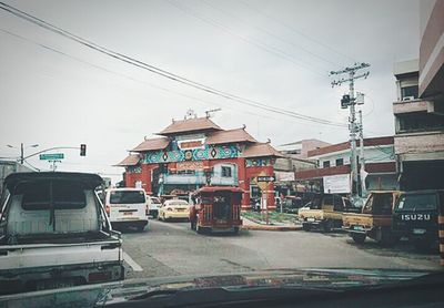 Cars on road against buildings