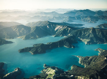 High angle view of lake and mountains against sky