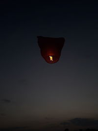 Low angle view of illuminated light against sky at night