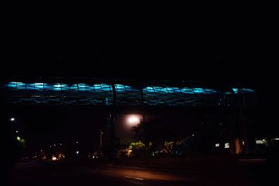 Illuminated road in city at night