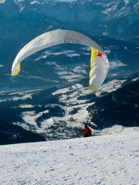 Paragliding in the alps in winter, outdoor sports in the mountains