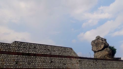 Low angle view of building against cloudy sky