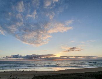 Scenic view of beach against sky during sunset