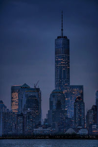 Illuminated cityscape against sky at night