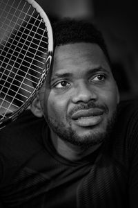 Close-up of man holding tennis racket