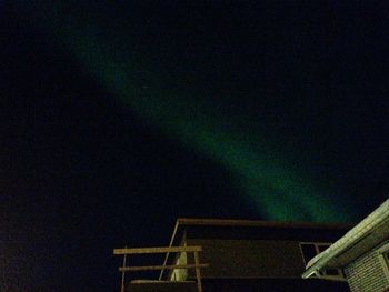 Low angle view of illuminated building against sky at night