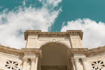 Low angle view of historical building against cloudy sky