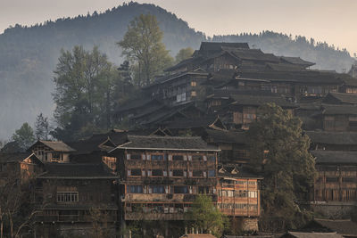 Residential buildings against sky at dusk