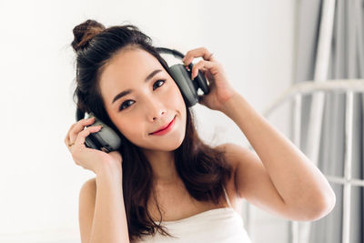 Portrait of young woman holding camera