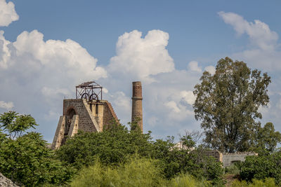 Low angle view of old factory against sky