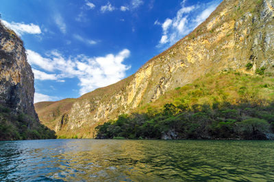 Calm lake with mountains in background