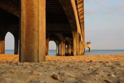 Built structure on beach against sky