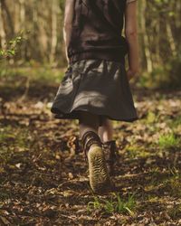 Rear view of girl walking in the forest