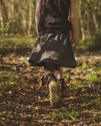 Rear view of girl walking in the forest