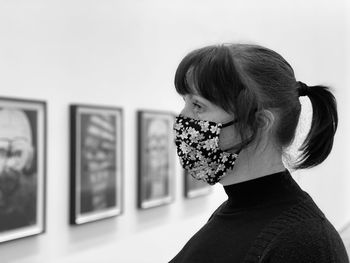 Portrait of woman standing against wall