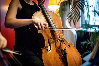 Midsection of woman playing in restaurant