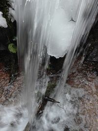 Scenic view of waterfall against sky