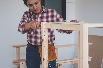 Midsection of man holding table at home