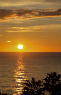 Scenic view of sea against romantic sky at sunset