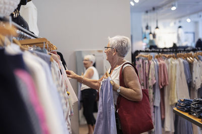 Senior woman doing shopping in clothes shop