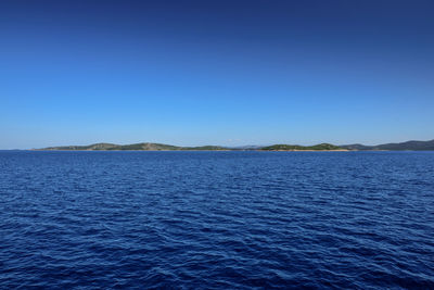 Scenic view of sea against clear blue sky