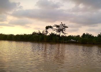 Scenic view of lake against sky at sunset