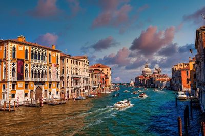 Boats in sea against buildings in city