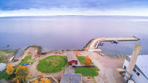 High angle view of sea by city against sky