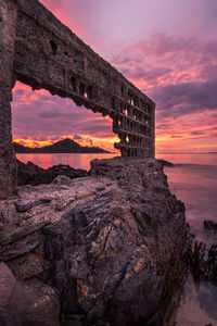 Scenic view of rock formation against sky at sunset