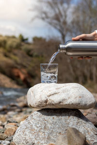 Close-up of drink on retaining wall