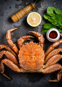 High angle view of crab by lemon on table