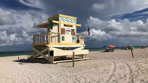 Lifeguard hut on beach against sky