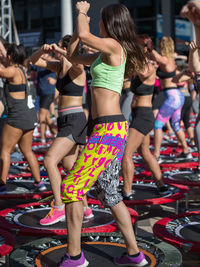 Rear view of women with people standing in the background