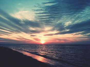 Scenic view of sea against sky at sunset