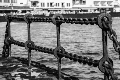 Close-up of chain against sea