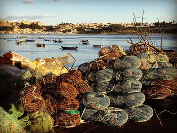 Crab pots at sea shore against sky