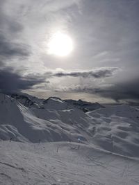 Scenic view of snow covered mountains against sky