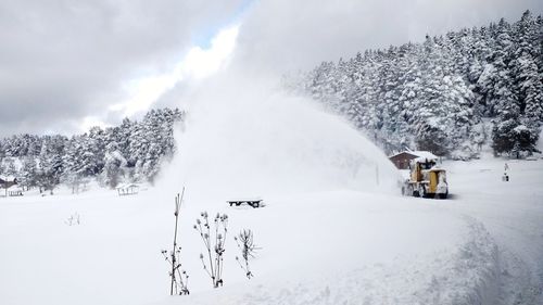 Snow covered land against sky