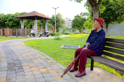 Senior woman sitting on bench at park