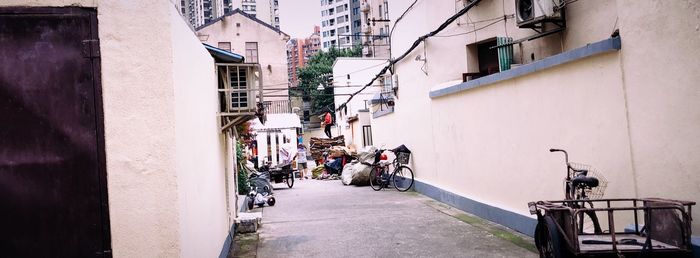 People on street amidst buildings in city