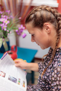 Young woman looking at book