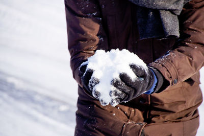 Low section of man standing on snow