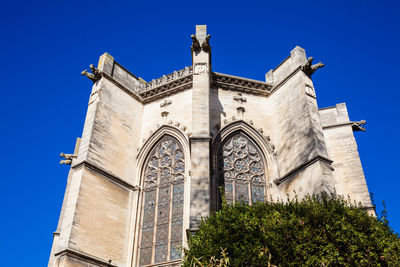 Low angle view of historic building against clear blue sky