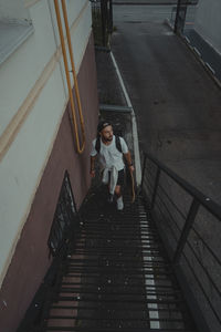 Rear view of woman walking on staircase