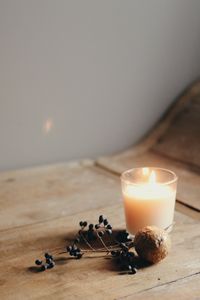 Close-up of illuminated candle on table